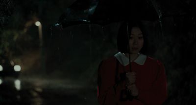 Still from Memories of Murder (2003) that has been tagged with: night & exterior & clean single & umbrella & rain