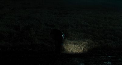 Still from Memories of Murder (2003) that has been tagged with: over-the-shoulder & field & night