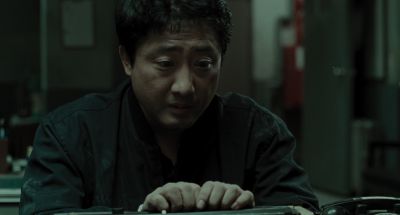 Still from Memories of Murder (2003) that has been tagged with: desk & office & clean single & interior & medium shot