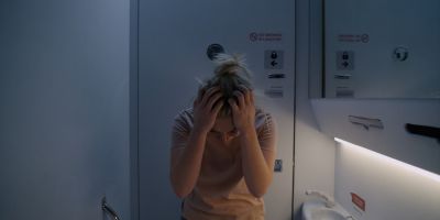 Still from Midsommar (2019) that has been tagged with: clean single & airplane & airplane interior & bathroom & medium shot