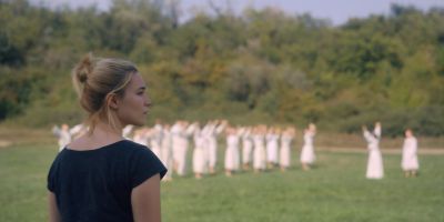 Still from Midsommar (2019) that has been tagged with: day & over-the-shoulder & wide shot & exterior