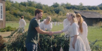 Still from Midsommar (2019) that has been tagged with: group-shot & exterior & medium wide & handshake