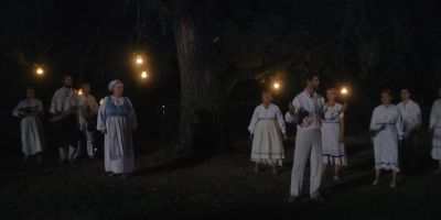 Still from Midsommar (2019) that has been tagged with: 6c551e & night & wide shot & group-shot