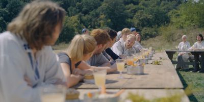 Still from Midsommar (2019) that has been tagged with: medium wide & banquet & exterior