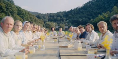 Still from Midsommar (2019) that has been tagged with: day & group-shot & banquet & exterior & medium wide