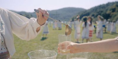 Still from Midsommar (2019) that has been tagged with: pouring & exterior