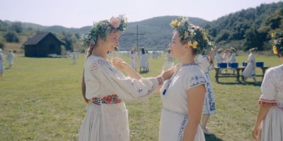 Still from Midsommar (2019) that has been tagged with: 1c352d & two-shot & exterior & profile shot