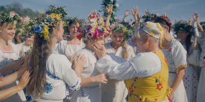 Still from Midsommar (2019) that has been tagged with: f4a662 & day & medium wide