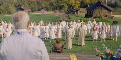 Still from Midsommar (2019) that has been tagged with: group-shot & field & wide shot & exterior & day