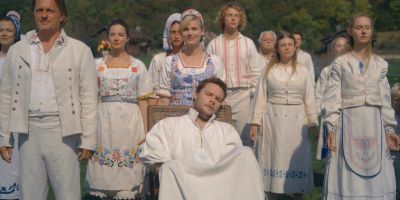 Still from Midsommar (2019) that has been tagged with: e1a960 & medium wide & day