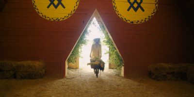 Still from Midsommar (2019) that has been tagged with: wide shot & wheelbarrow