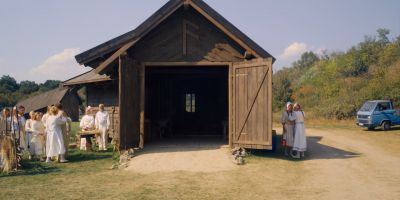 Still from Midsommar (2019) that has been tagged with: group-shot & wide shot & barn
