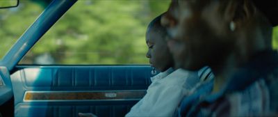 Still from Moonlight (2016) that has been tagged with: car interior & profile shot & medium close-up & two-shot & day
