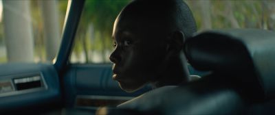 Still from Moonlight (2016) that has been tagged with: 546a2f & day & medium close-up & car interior