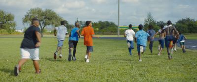 Still from Moonlight (2016) that has been tagged with: exterior & football field & soccer & wide shot & field