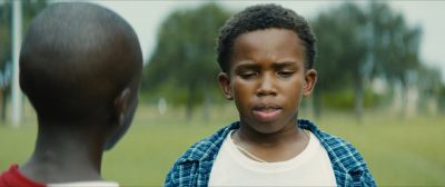 Still from Moonlight (2016) that has been tagged with: 836a54 & over-the-shoulder & medium close-up & day