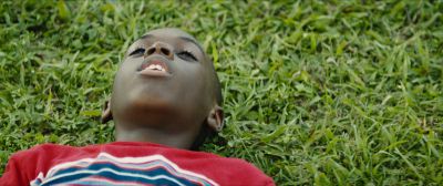 Still from Moonlight (2016) that has been tagged with: medium close-up & grass