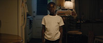 Still from Moonlight (2016) that has been tagged with: night & practical lamp & medium wide & interior & clean single & apartment