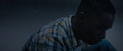 Still from Moonlight (2016) that has been tagged with: night & interior & medium close-up & clean single & profile shot
