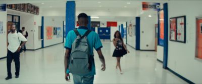 Still from Moonlight (2016) that has been tagged with: ab4f53 & wide shot & hallway & over-the-shoulder & high school