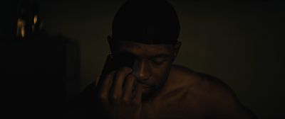 Still from Moonlight (2016) that has been tagged with: night & cellphone & close-up & interior
