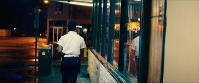 Still from Moonlight (2016) that has been tagged with: ffbb00 & over-the-shoulder & night & restaurant