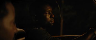 Still from Moonlight (2016) that has been tagged with: night & interior & over-the-shoulder & medium close-up & driving