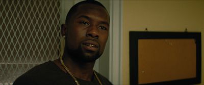 Still from Moonlight (2016) that has been tagged with: 714f38 & interior & medium close-up & clean single