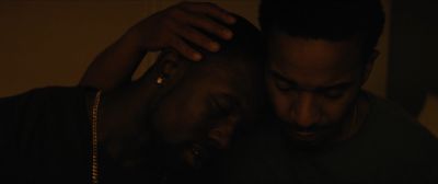 Still from Moonlight (2016) that has been tagged with: 483c32 & two-shot & medium close-up