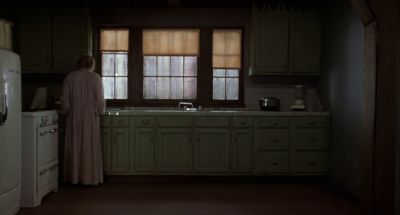 Still from Mulholland Drive (2001) that has been tagged with: 0f0f0f & over-the-shoulder & wide shot & kitchen