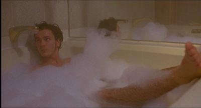 Still from My Own Private Idaho (1991) that has been tagged with: 4f404c & clean single & medium wide & bathtub & interior