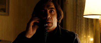 Still from No Country For Old Men (2007) that has been tagged with: night & interior & phone & medium close-up & practical lamp