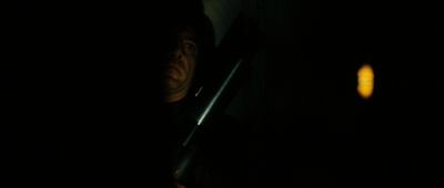 Still from No Country For Old Men (2007) that has been tagged with: night & interior & clean single & medium close-up & gun