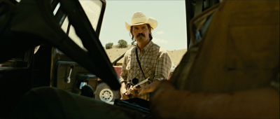 Still from No Country For Old Men (2007) that has been tagged with: car interior & over-the-shoulder & medium wide & day