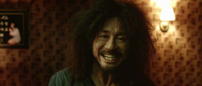 Still from Oldboy (2003) that has been tagged with: laughing & close-up