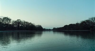 Still from Only the River Flows (2023) that has been tagged with: 4d5c52 & day & exterior