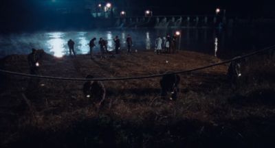 Still from Only the River Flows (2023) that has been tagged with: extreme wide & night & group-shot