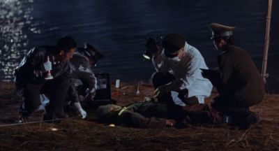 Still from Only the River Flows (2023) that has been tagged with: exterior & police & dead body