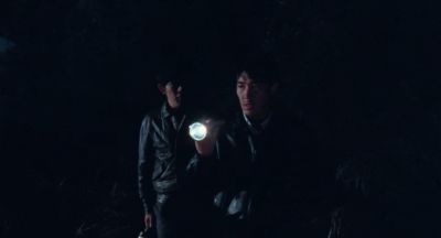 Still from Only the River Flows (2023) that has been tagged with: three-shot & exterior & flashlight