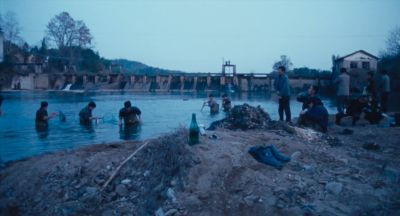 Still from Only the River Flows (2023) that has been tagged with: extreme wide & river & day