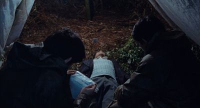 Still from Only the River Flows (2023) that has been tagged with: rain & dead body & night