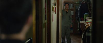 Still from Parasite (2019) that has been tagged with: two-shot & medium wide & hallway & day