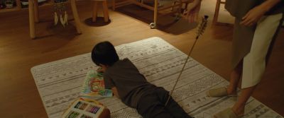 Still from Parasite (2019) that has been tagged with: interior & child & drawing & bow and arrow