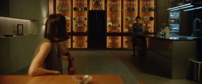 Still from Parasite (2019) that has been tagged with: interior & wide shot & kitchen & over-the-shoulder