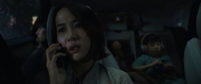 Still from Parasite (2019) that has been tagged with: clean single & cellphone & car interior