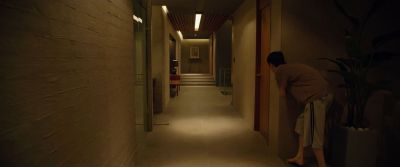 Still from Parasite (2019) that has been tagged with: peeking & clean single & night & interior & wide shot & hallway