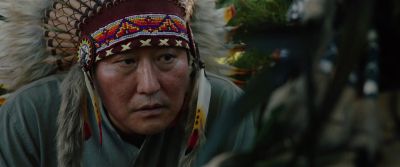 Still from Parasite (2019) that has been tagged with: war bonnet & shamans eyes