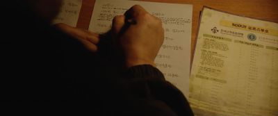 Still from Parasite (2019) that has been tagged with: handwriting & morse code