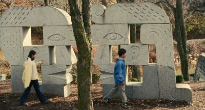 Still from Past Lives (2023) that has been tagged with: sculpture & exterior