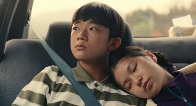 Still from Past Lives (2023) that has been tagged with: car interior & backseat & sleeping